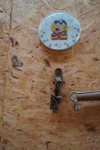 lot 140 image: Thermometer and iron piece on wall