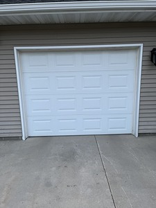 lot 224 image: Like New 9 x 7 insulated overhead door with hardware