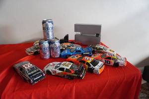 lot 147 image: Box of Die cast cars & trucks, 3 Bush Light cans