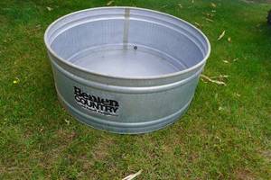 lot 203 image: Round Galvanized Stock tank 57 Wide and 23 Deep