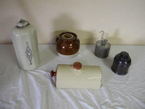 lot 556 image: Stoneware flasks, crock, candle