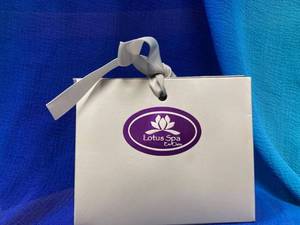 lot 73 image: Lotus Spa $50 gift Certificate and Tangled up in Hue basket