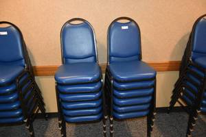 lot 89 image: 12 stackable blue padded chairs