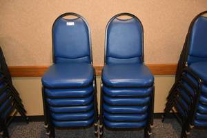 lot 90 image: 12 stackable blue padded chairs