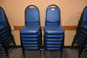 lot 92 image: 12 stackable blue padded chairs