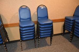 lot 93 image: 12 stackable blue padded chairs
