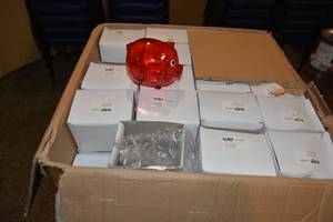 lot 226 image: Case of red piggy banks etc.