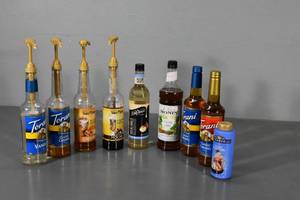 lot 131 image: Assorted coffee flavorings and some dispensers