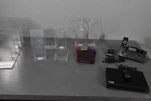 lot 135 image: Acrylic display racks, Sanyo DVD player, phone