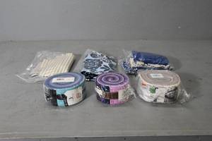 lot 134 image: 3) Jelly Rolls, 3) pieces fabric
