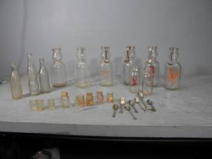 lot 20 image: Adv. Bottles,5) cream top spoons