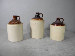 lot 74 image: Three shoulder jugs with brown tops