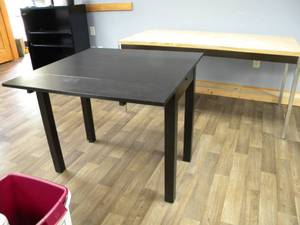 lot 233 image: Black table with hide away leaves 20 x 36 x 29