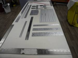 lot 156 image: 8) Metal rulers, 2 squares, 2) cuff units, guides