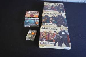 lot 28 image: Malifaux, box with minis and cards