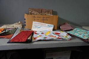 lot 61 image: Large box of multi colored fabric lengths