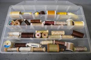 lot 105 image: Case of thread-YellowGoldBrown