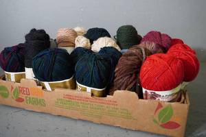 lot 144 image: 30 skeins redbluegreenblack yarn