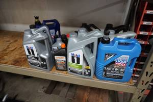lot 11 image: Motor oil partical assorted jugs of oil