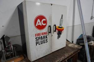 lot 70 image: AC Fire Ring Spark Plug metal cabinet