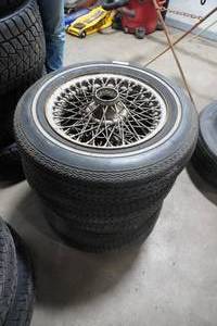 lot 125 image: 4) Wire wheel rims and tires MG  165 15