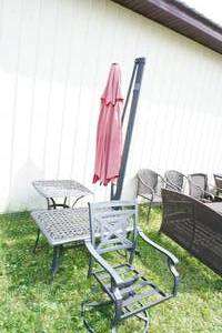 lot 68 image: Four piece wrought iron patio set with Umbrella & stand
