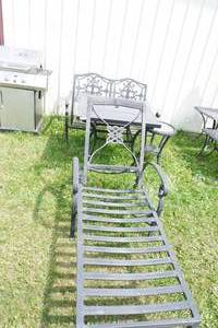 lot 69 image: Four piece wrought iron set, bench, lounger, tables