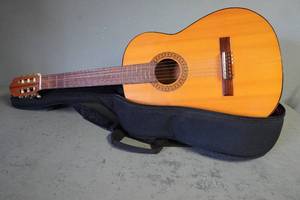 lot 96 image: Six string acoustic guitar and case