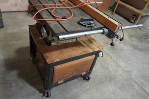 lot 118 image: Craftsman table saw on roller wheels