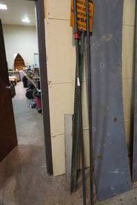 lot 219 image: Two 12 pipe clamps and sign on steel post