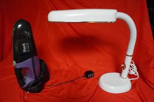 lot 57 image: Shark Cordless hand vacuum and white desk lamp