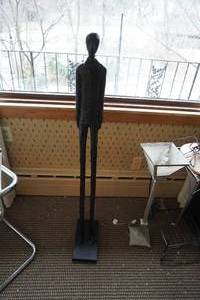lot 62 image: Tall long legged statue of man