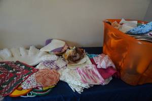 lot 169 image: Tub of Doillies, linens, pot holders, wash cloths
