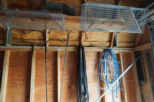 lot 371 image: 2) Live traps, items along wall on east wall of shed