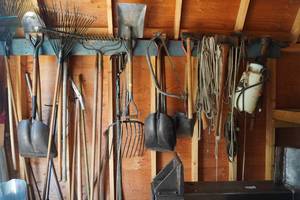 lot 375 image: Yard tools on West wall, shovels, rope etc...