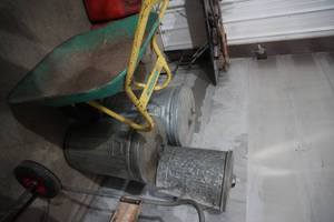 lot 20 image: 3 Empty garbage cans wlids metal, wheel barrow