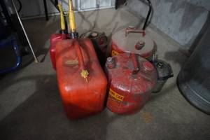 lot 21 image: Gas cans-6 2 poly and 4 metal