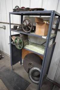 lot 96 image: Metal shelf with compressor, gears, cast iron